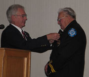 Lawrence Ruff accepts 2006 NVFC Volunteer Firefighter of the Year from Joe Guyotte